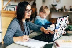 Mother working at home with toddler